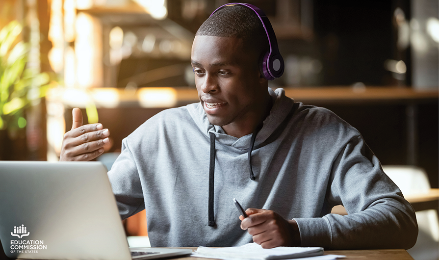 college age student with headphones attending online class